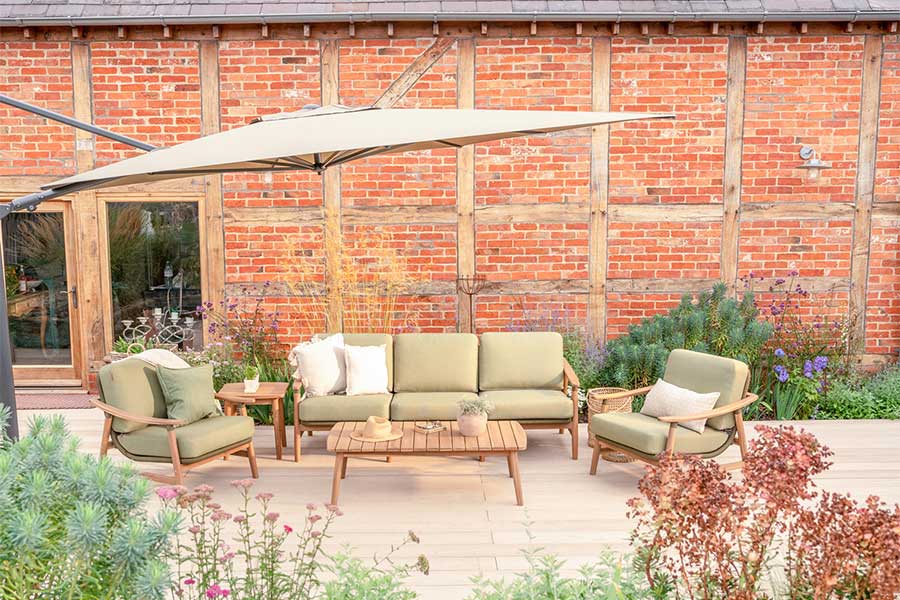 Kettler Meadow acacia wood garden lounge set with sage green cushions on a garden patio