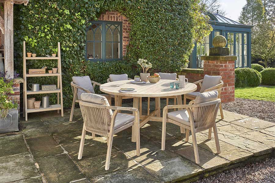 Kettler Cora 6 seat round hardwood dining set on a lovely cottage patio