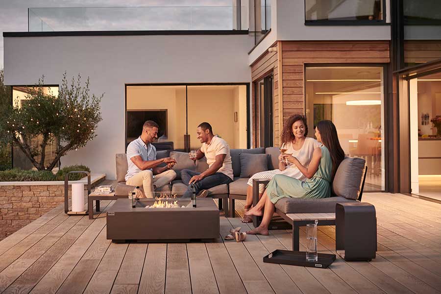 People enjoying a summer evening in the garden on a Kettler Elba lounge set