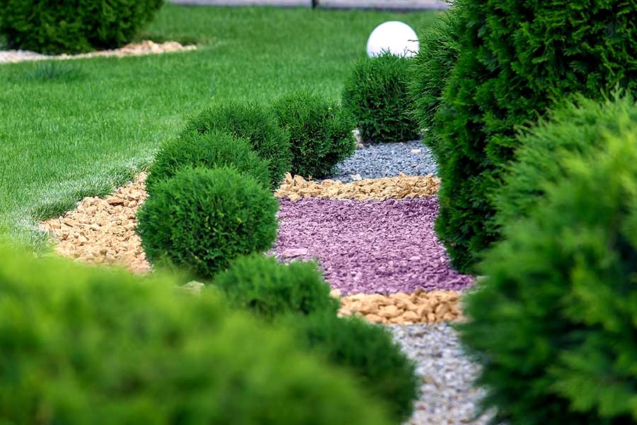 Garden mulched with decorative stone chippings in different colours